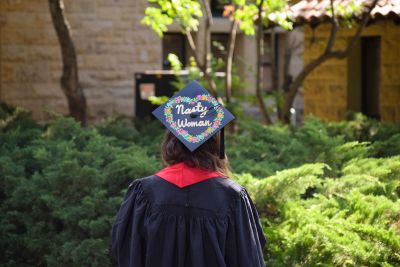 Student with the words Nasty Woman written in sparkles on her mortarboard