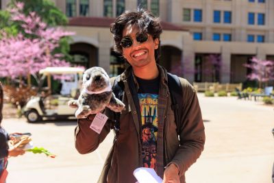 Student holding a stuffed animal.