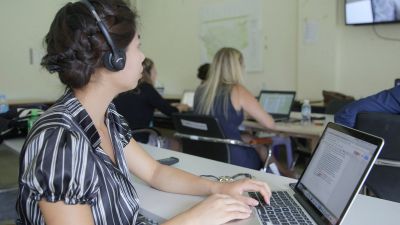 woman wearing headphones working on a laptop
