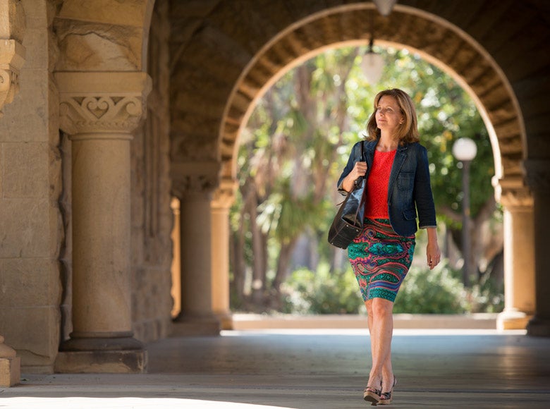 DCI Fellow Kate Jerome walking in Quad arcade