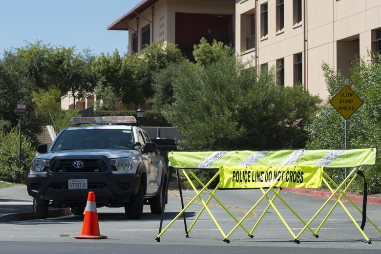police car blocking entry to garage at business school because of bomb threat