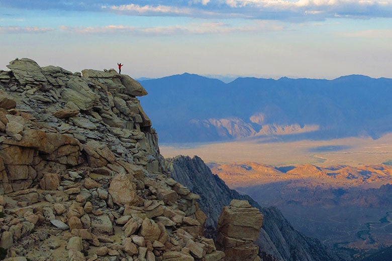 Stanford Earth alum Hari Mix standing atop the Sierra Nevada