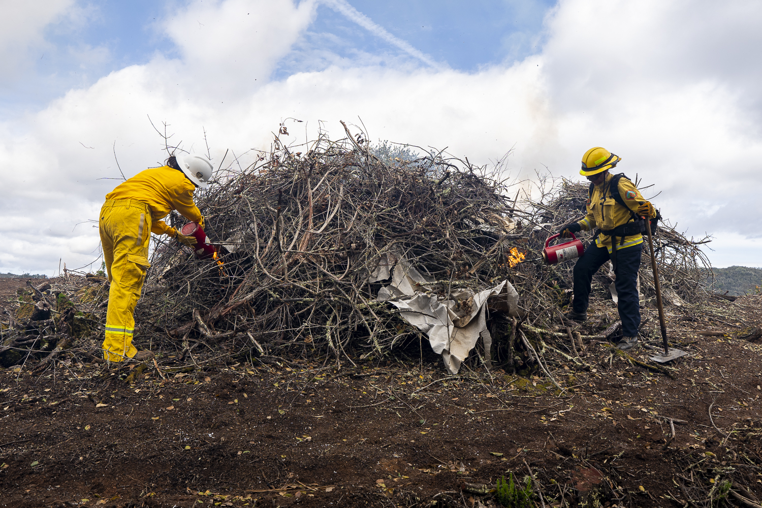 Firefighters ignite a pile with drip torches at Jasper Ridge Biological Preserve – 'Ootchamin 'Ooyakma.