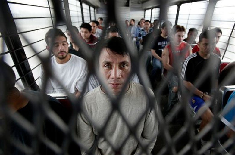 Immigrants on a U.S. Immigration and Customs Enforcement bus heading for deportation