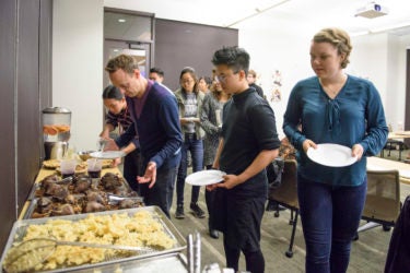 class members loading their plates at the buffet line