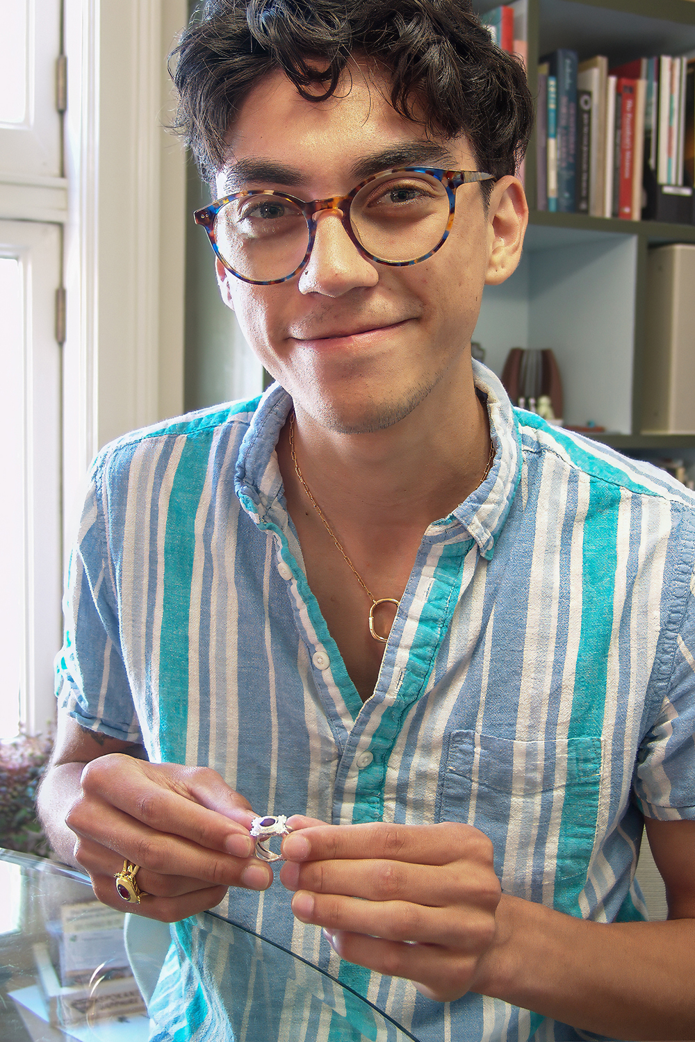 Senior product design major David Durand wearing the gold and silver class rings that he designed and crafted.