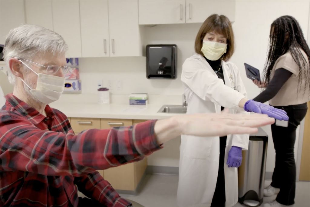 Neurologist Helen Bronte-Stewart works with patient Keith Krehbiel.