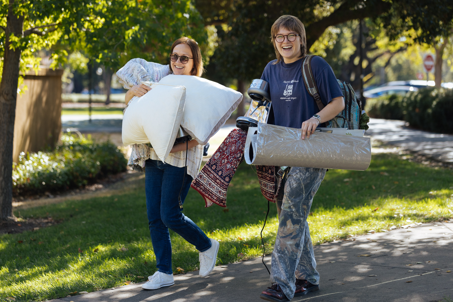 Family member helps student carry in belongings.