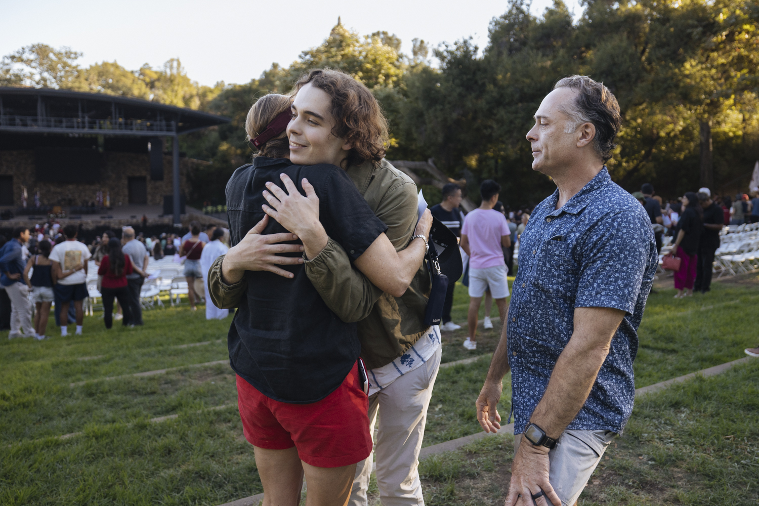 Student and family members hug.