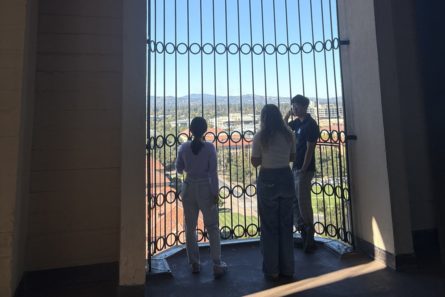 Image of PhD students looking out at campus from the top of Hoover Tower.