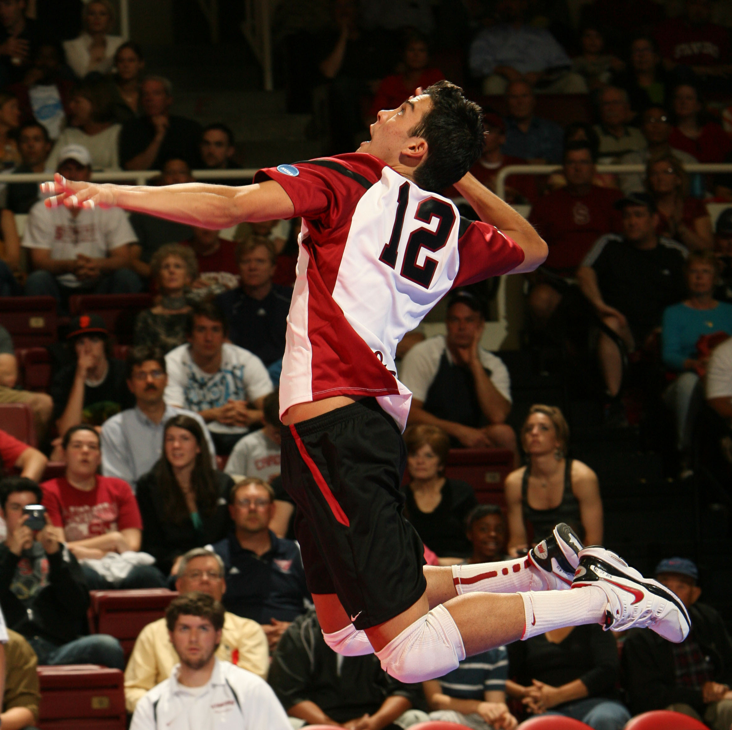 Kawika Shoji jumps to hit a volleyball at Stanford