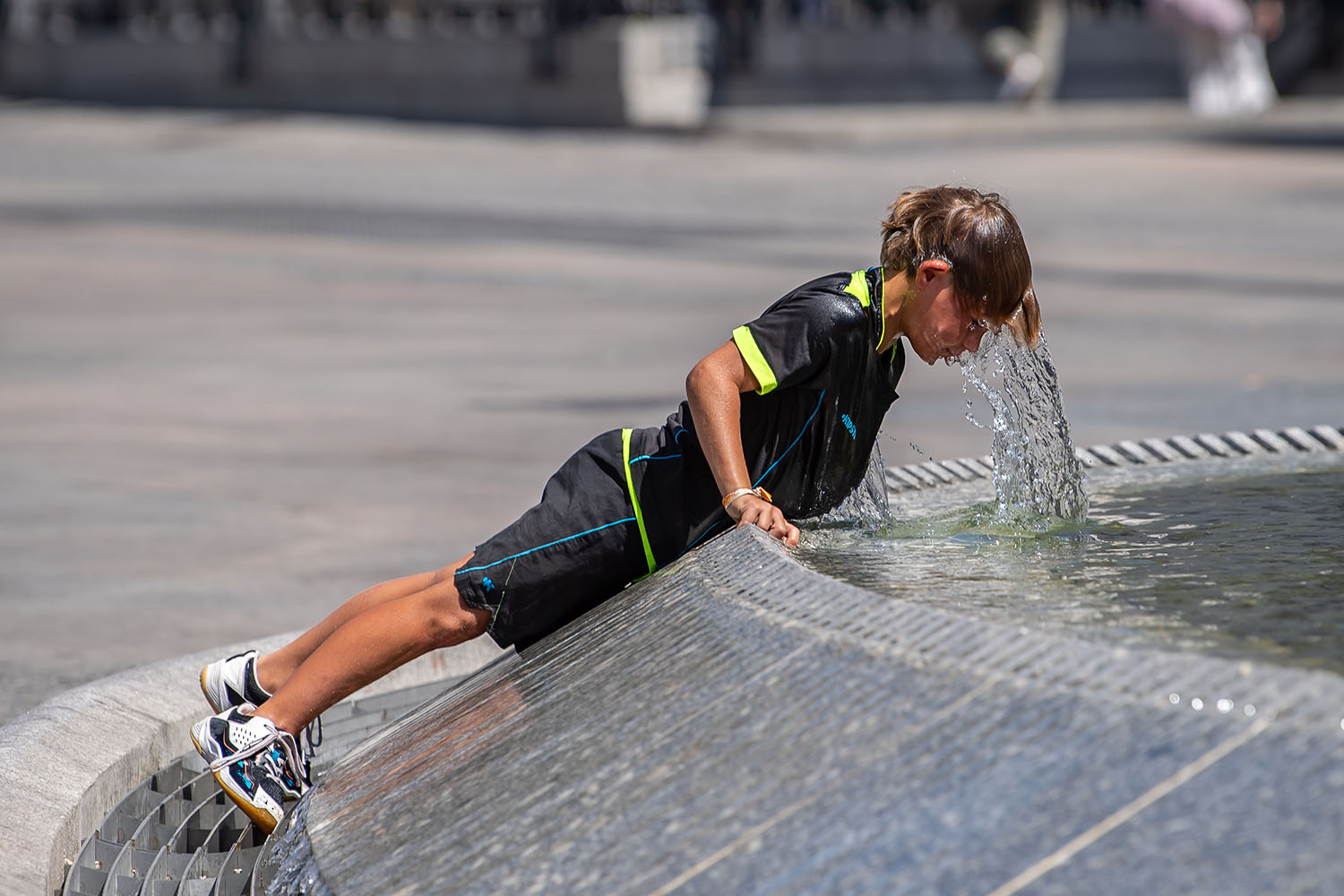 Kid cools off in a fountain at the Puerta del Sol on July 17, 2025, in Madrid, Spain. 