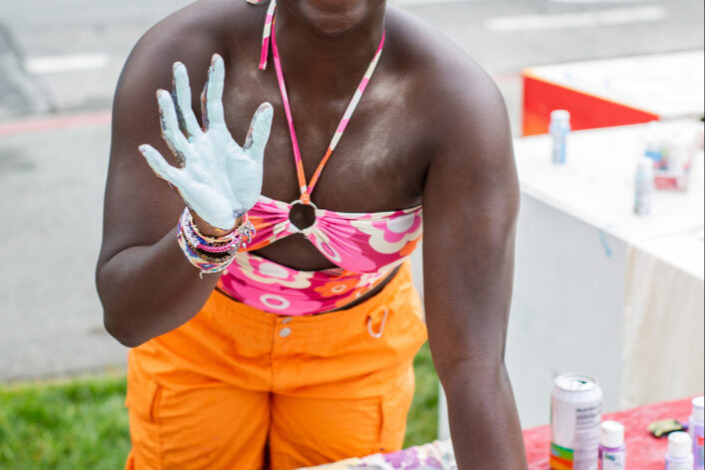 Student at a table decorating a t-shirt.