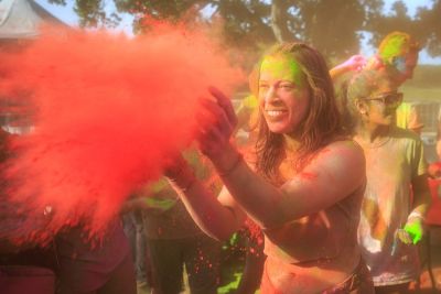 Student throwing red colored dust.