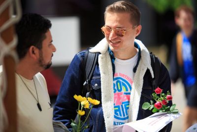 Two students with flowers.