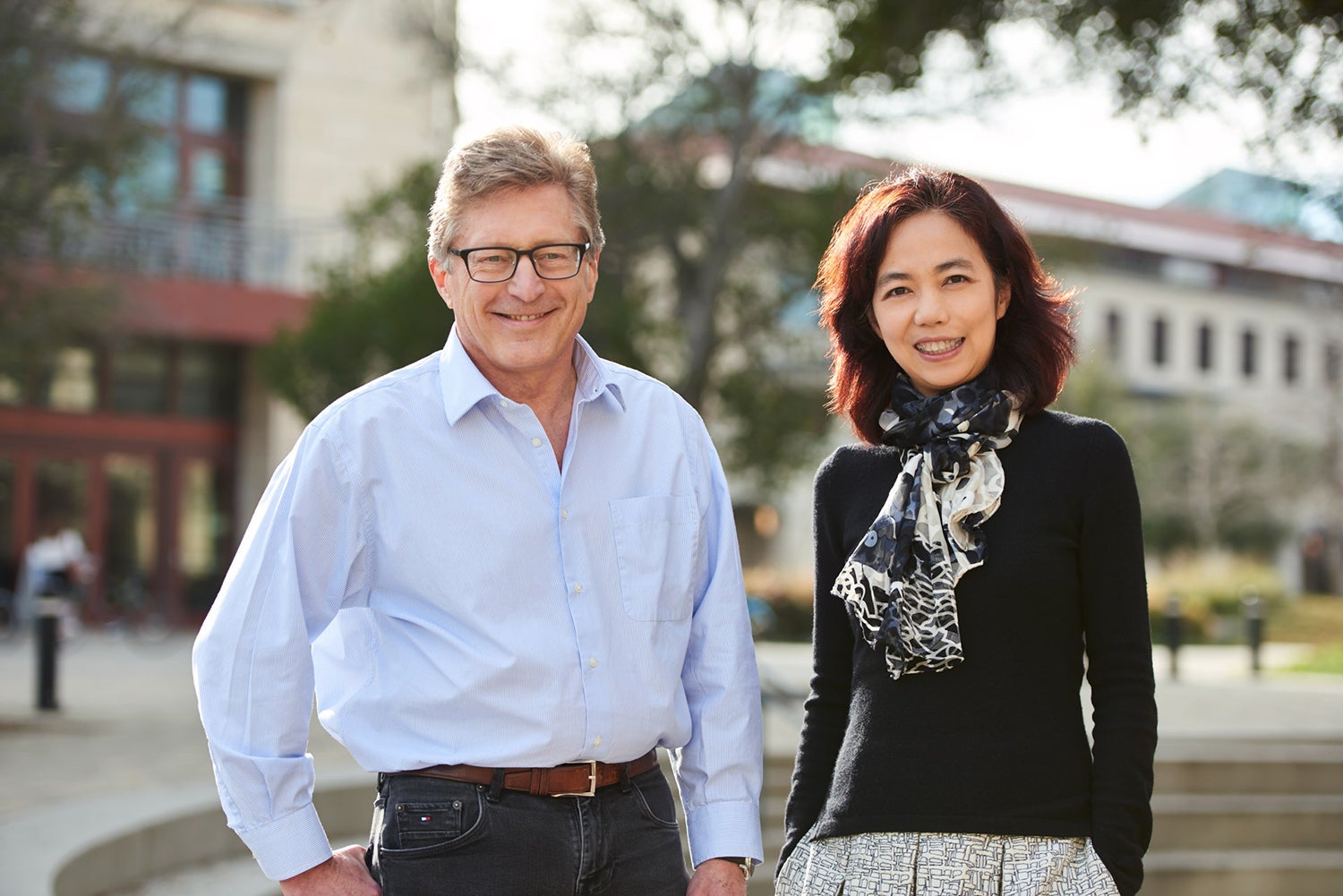 John Etchemendy and Fei-Fei Li stand together, smiling.
