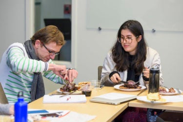 students eating wood pigeon on toast