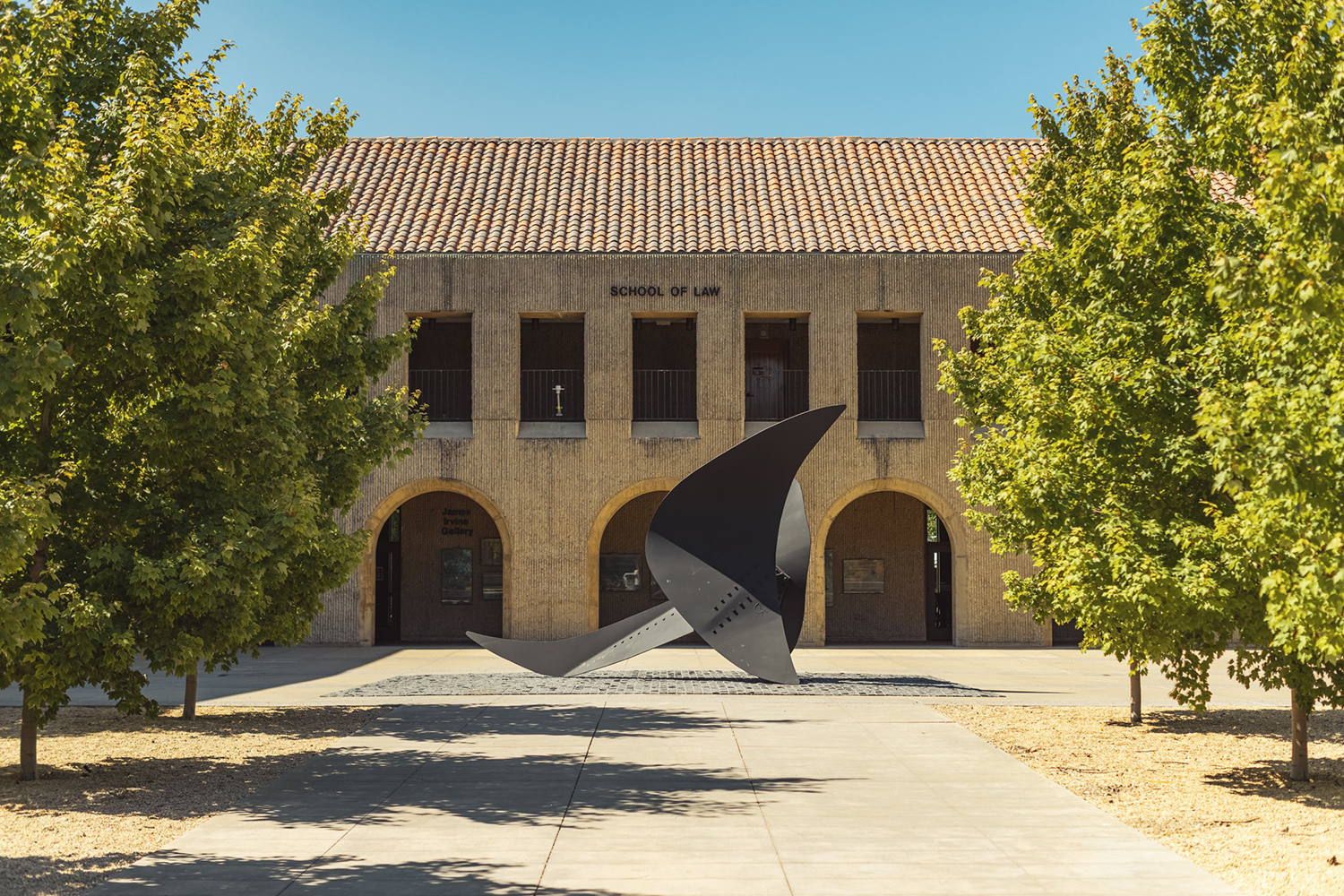 Large-scale steel abstract sculpture suggesting a winged creature situated in front of the Stanford Law School.