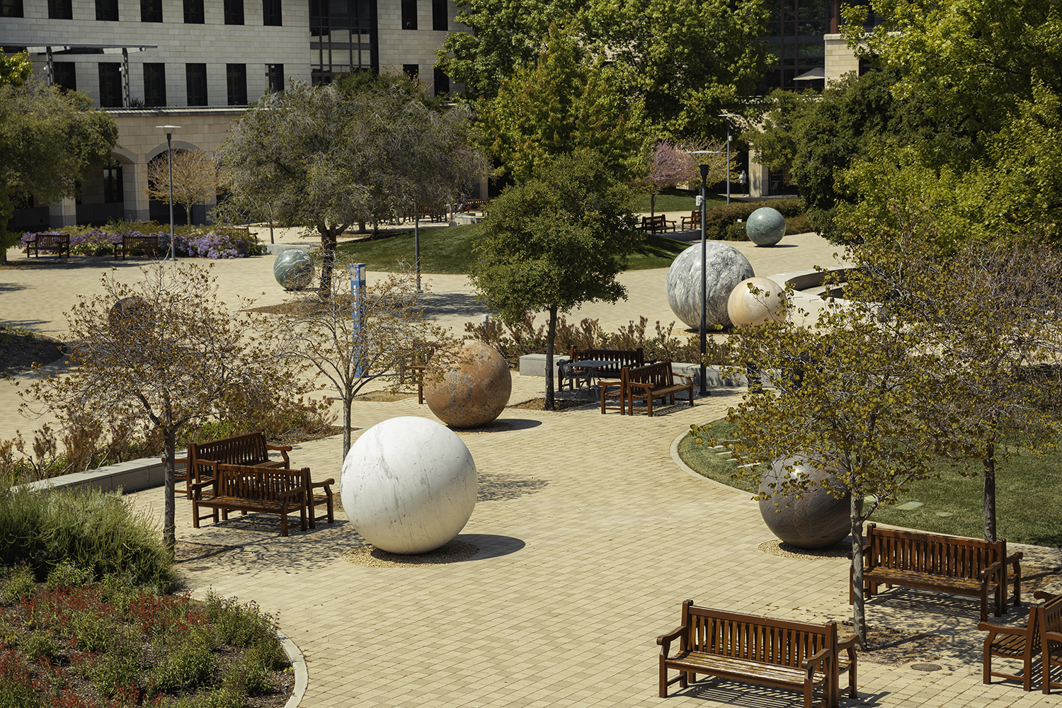 Five stone spheres of various sizes installed on pavers in Stanford’s Science and Engineering Quad.