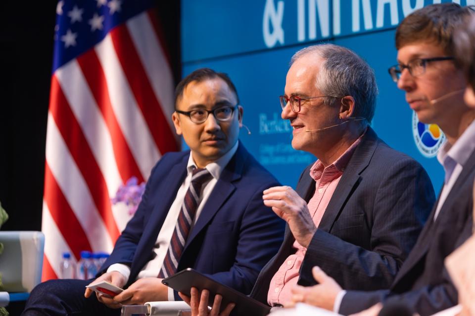 Dan Ho, left, and Chris Manning at a panel discussion.