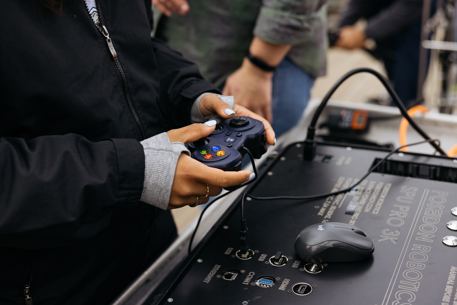 An up close photo of someone holding a PlayStation 4 controller.