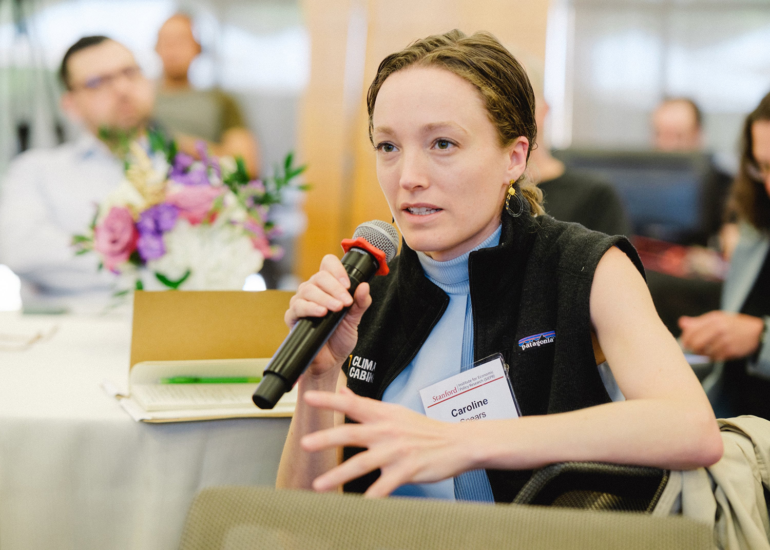 Caroline Spears, founder of Climate Cabinet, poses a question to panelists.
