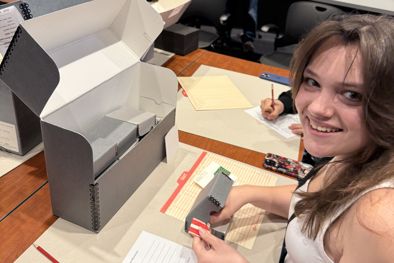 Image of a student holding a war medal housed at the Hoover Institution.