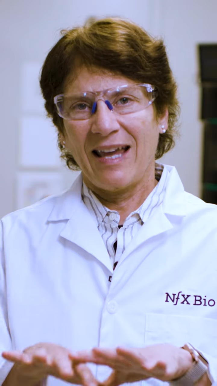 Vertical image of Carolyn Bertozzi speaking to the camera about her research.