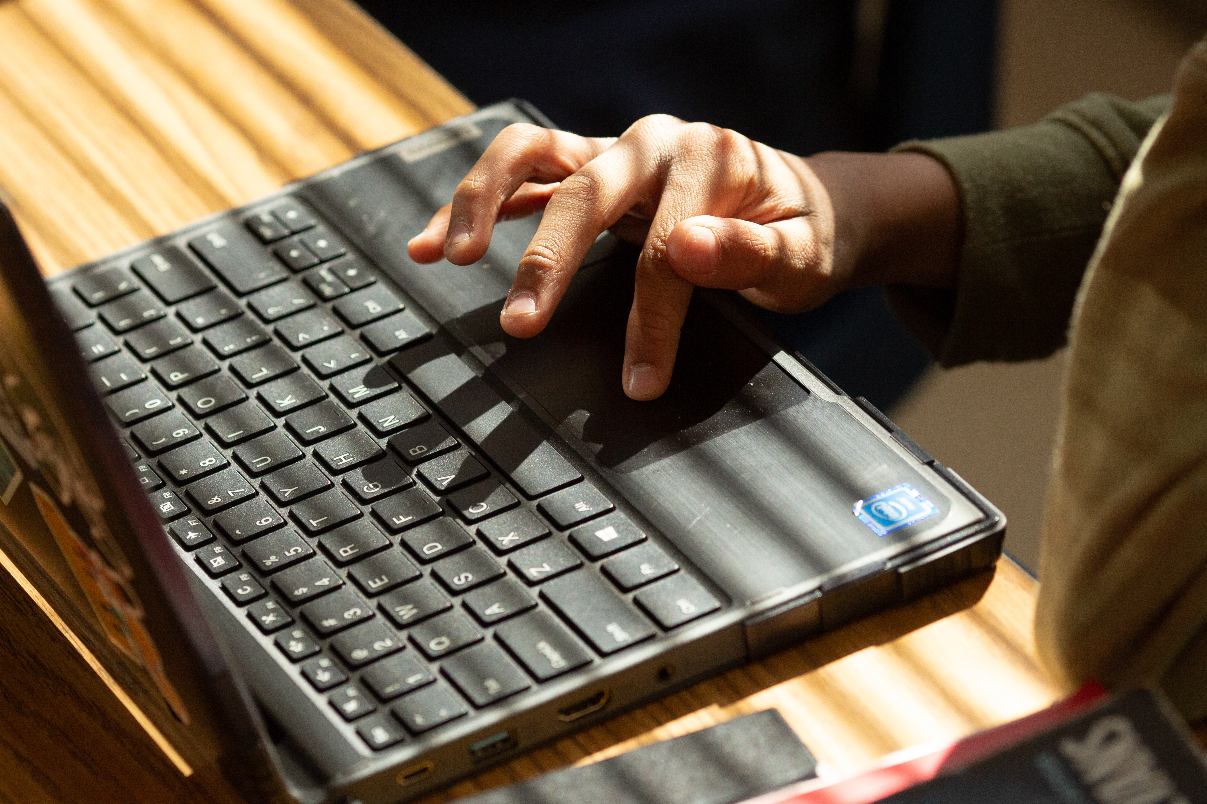 Close-up of hands on a laptop computer