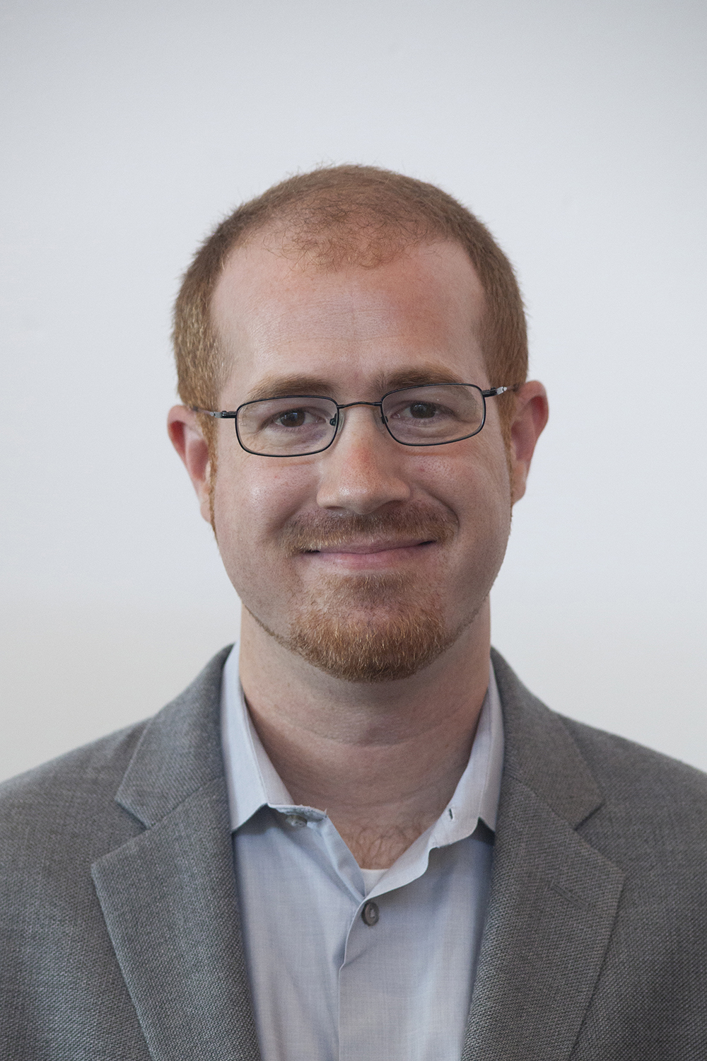 Aaron Newman posing for a profile photo against a neutral background.
