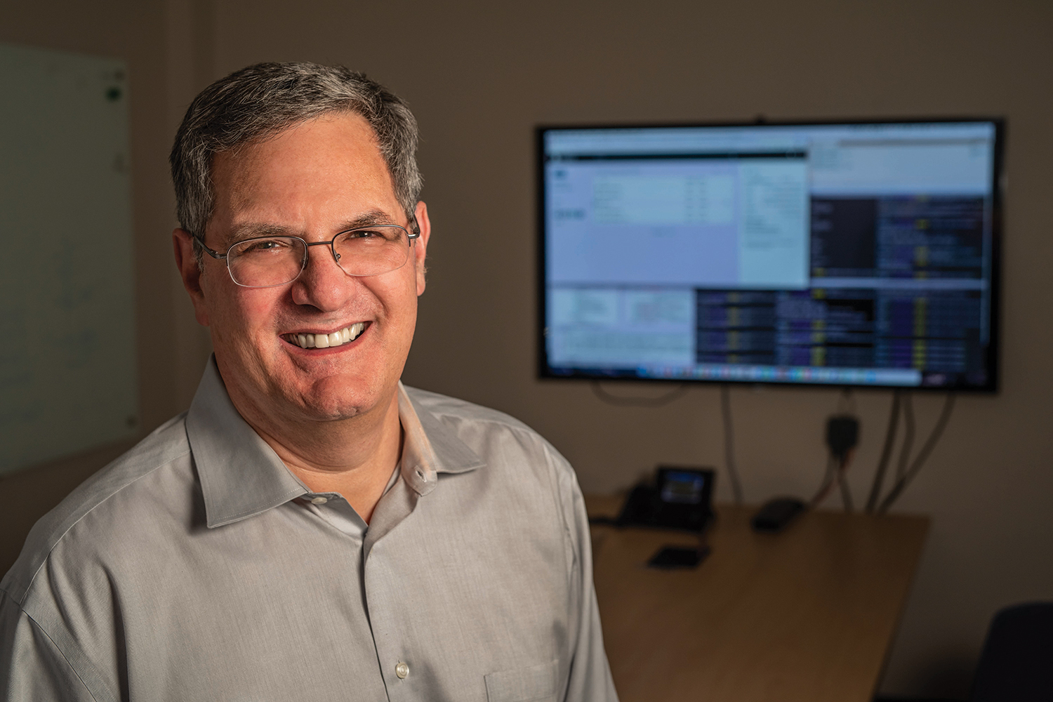 Mark Musen smiling for a profile photo against a neutral, indoor background.