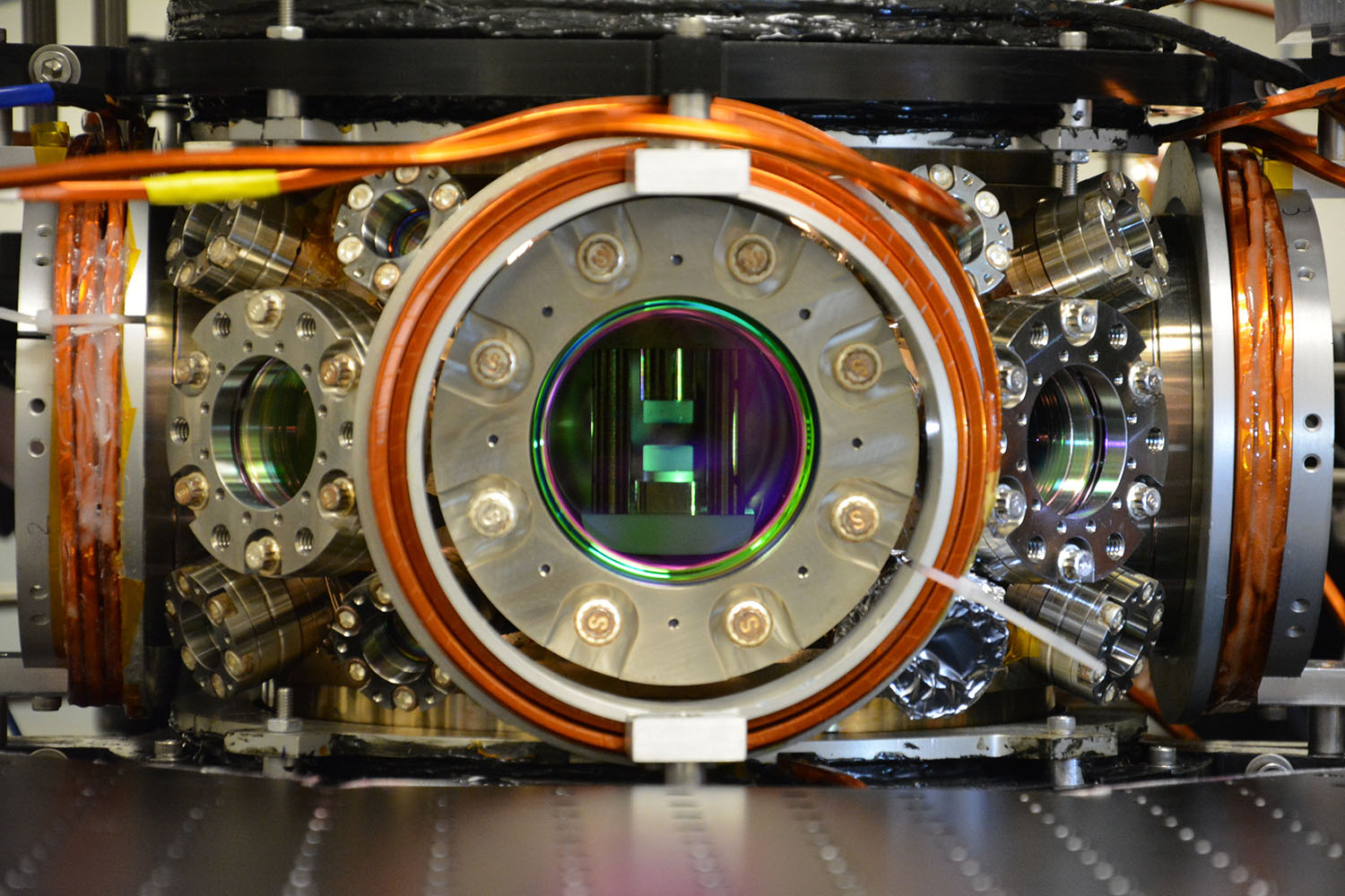 A metal piece of equipment with a round open chamber in the center.