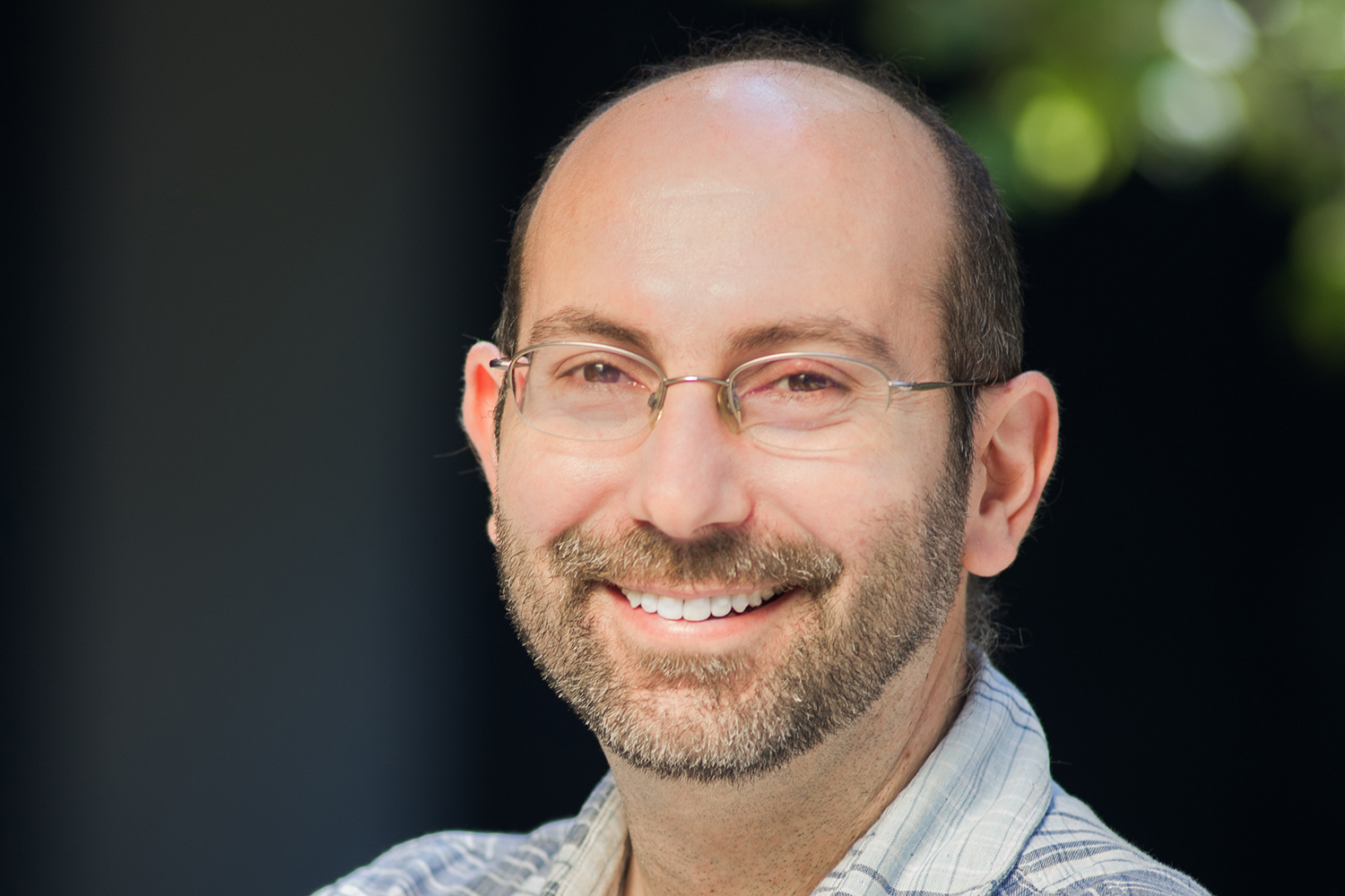 Paul Nuyujukian smiling and posing for a profile photo outdoors.
