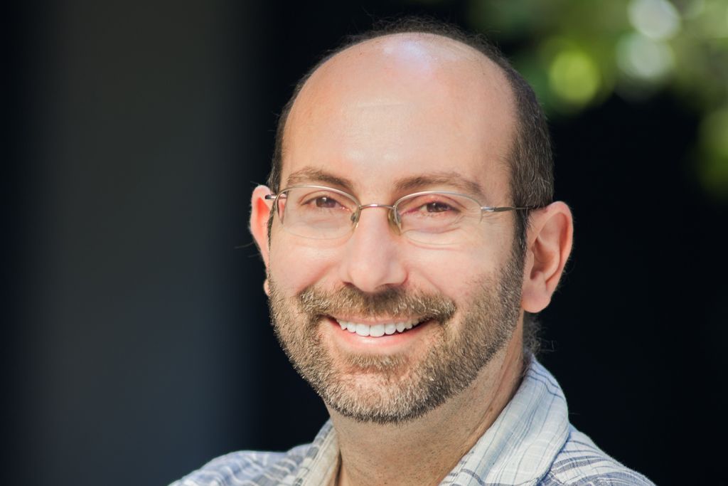 Paul Nuyujukian smiling and posing for a profile photo outdoors.