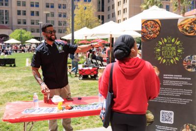 Staff members speaking to a student at a table.