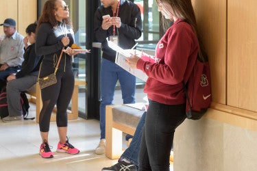 students and family members looking at schedules in Arrillaga Alumni Center