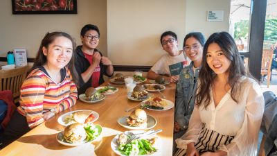 Qin and other diners at a table.