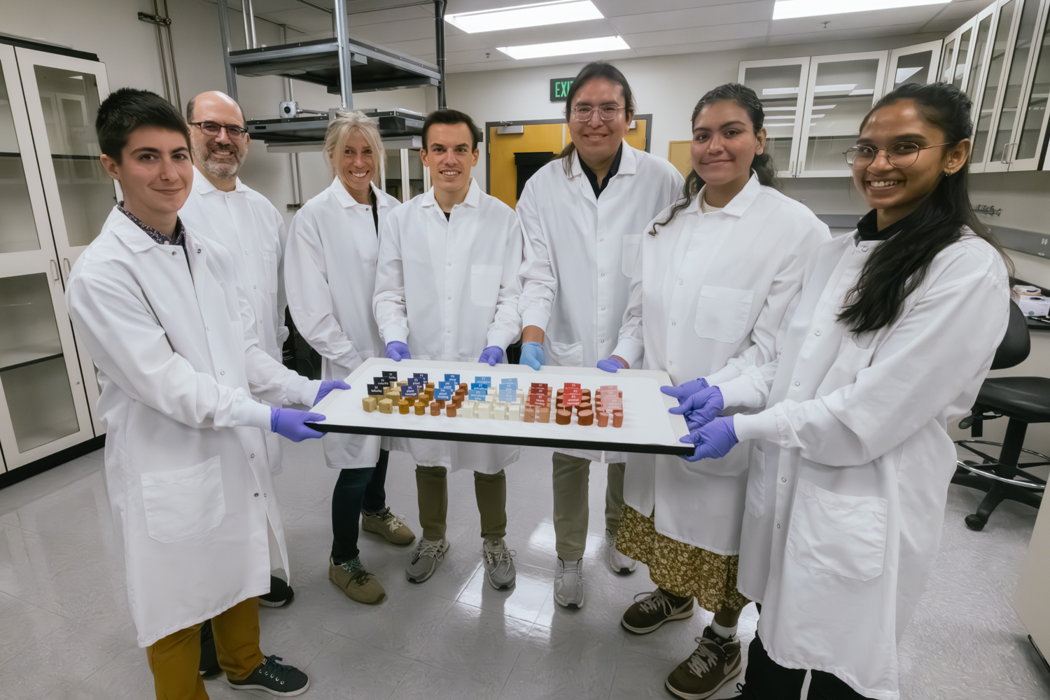 Skyler St. Pierre, Marc Levenston, Ellen Kuhl, Reese Dunne, Ethan Darwin, Valerie Perez Medina, and Divya Adil pose with the meat and plant-based meat they analyzed.