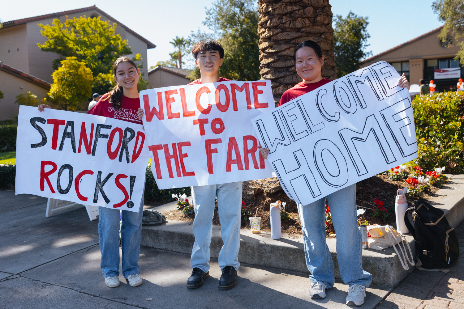 Orientation coordinators hold banners welcoming new students.