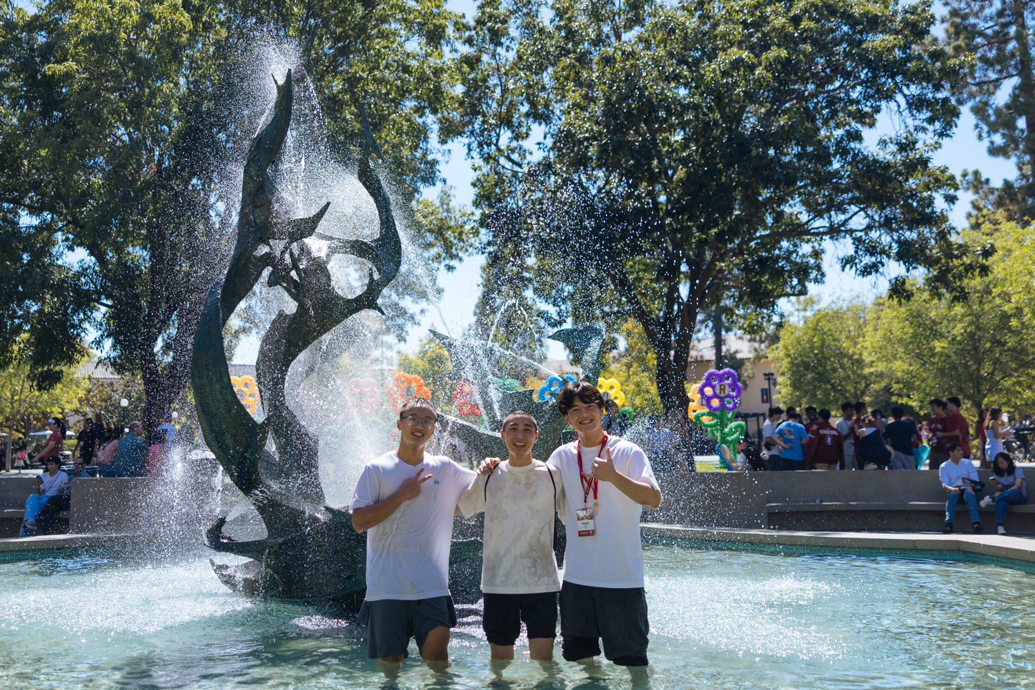 Students hop in the fountain at White Plaza.