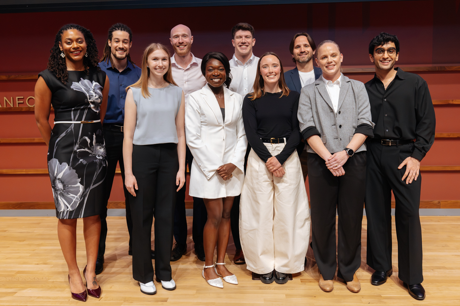Group of ten competition finalists standing together on stage.