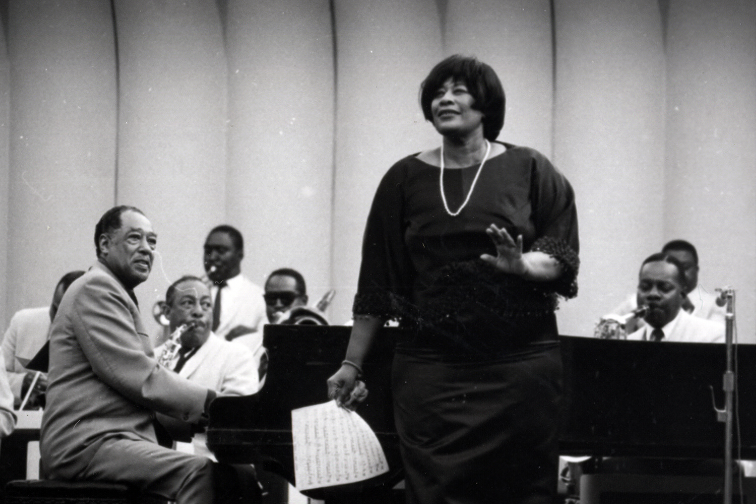 Duke Ellington and Ella Fitzgerald perform on stage.