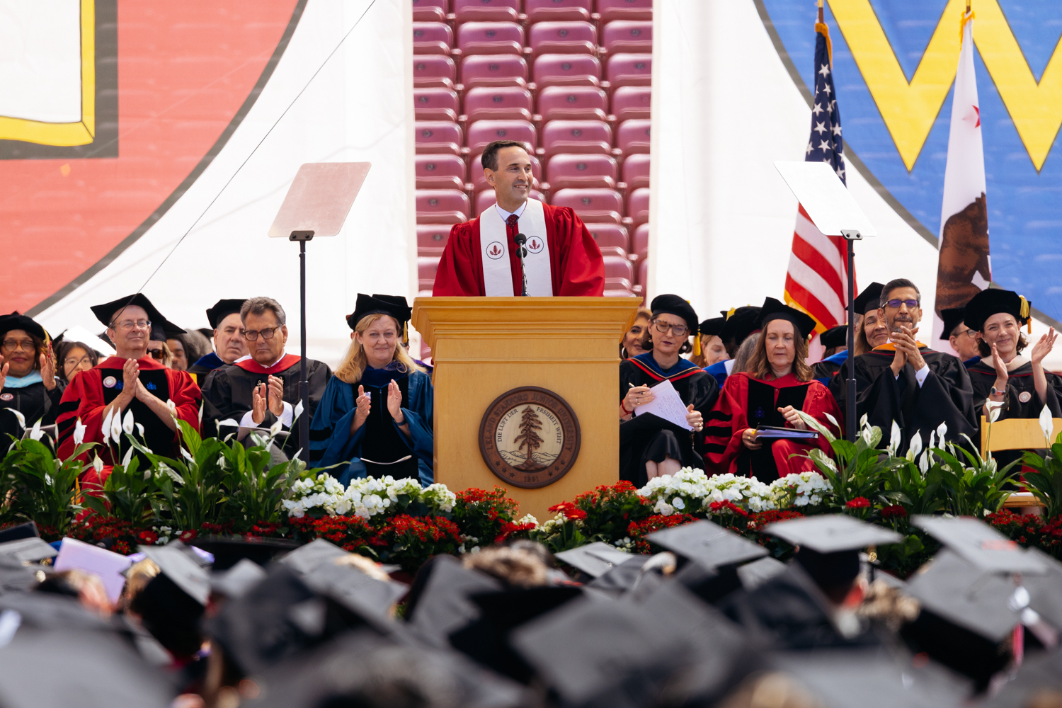 Open video President Levin in red academic robes delivers his remarks at outdoor commencement ceremony. in a modal
