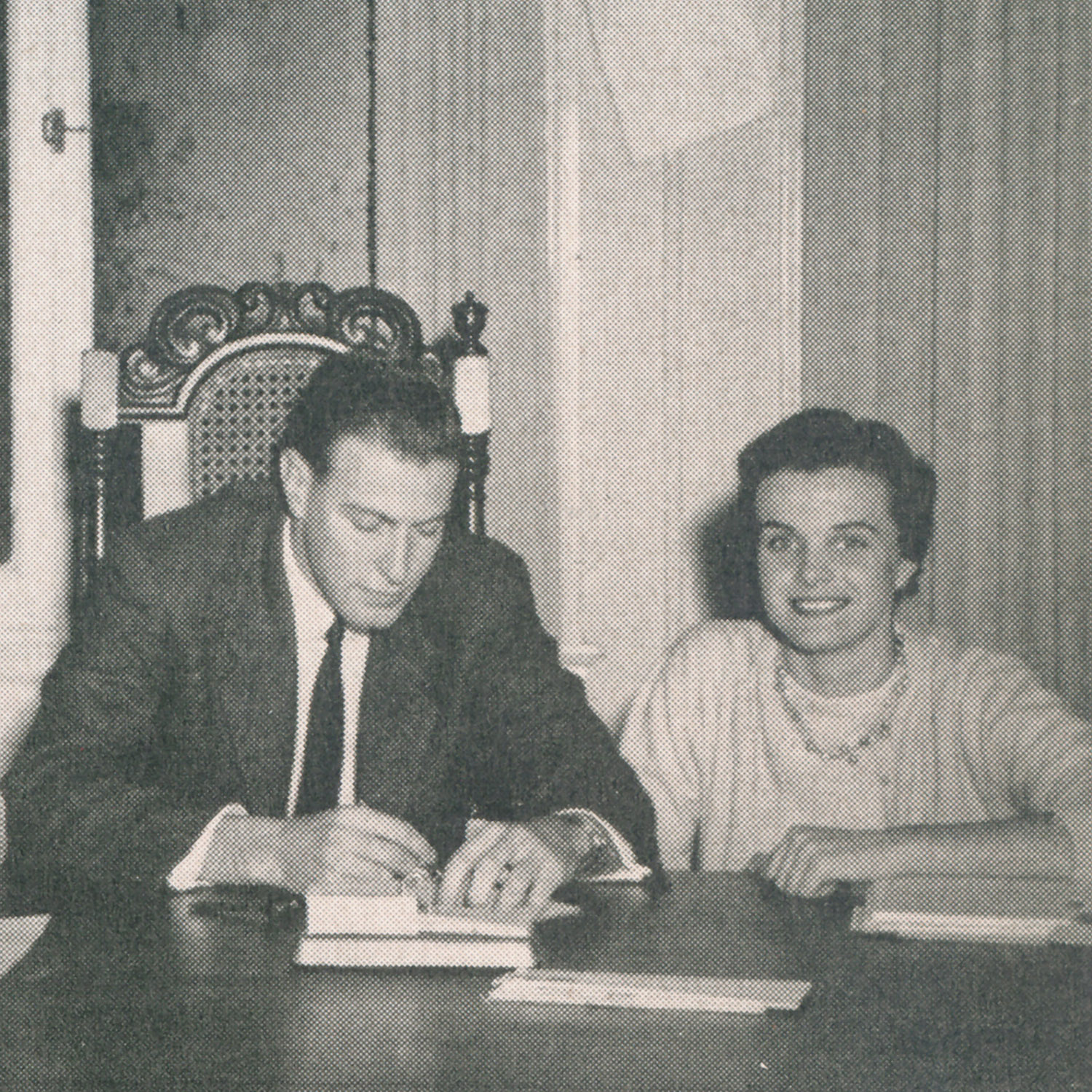 Black and white photograph from college yearbook of Peter Bing and Dianne Feinstein seated at a desk with papers and books.