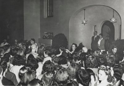 Students serenade Donald and Mary Tresidder outside the presidential residence