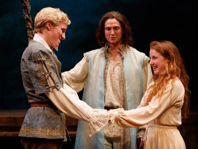 In a production of Shakespeare’s The Tempest, Miles Petrie and Emma Rothenberg are Ferdinand and Miranda, while Tim Schurz as Prospero looks on.