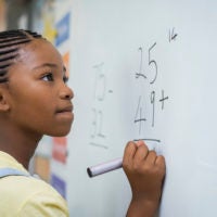 Girl solving math problem