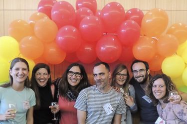 Attendees posing by balloons.