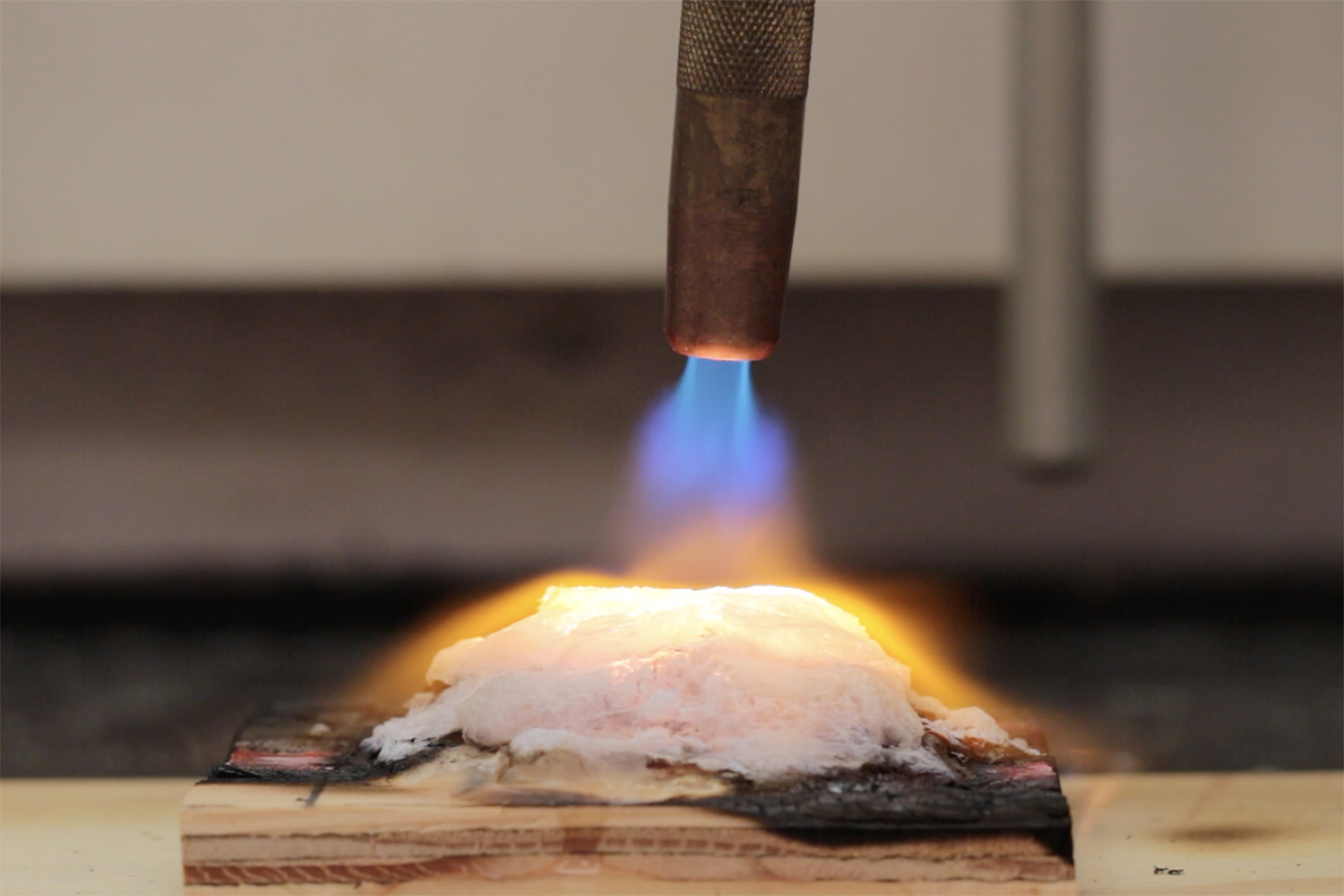 The researchers used a gas hand-torch to test how the new gel protected a piece of plywood.