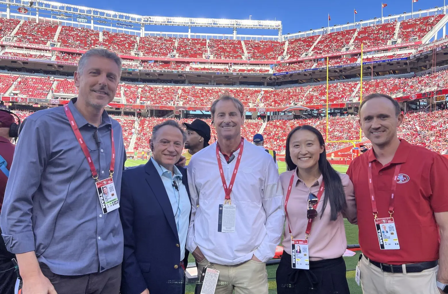 Michelle stands with other members of the 49ers ' medical team on the stadium sidelines.